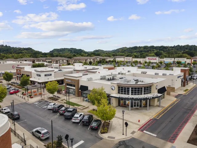a view of a terrace with lawn chairs