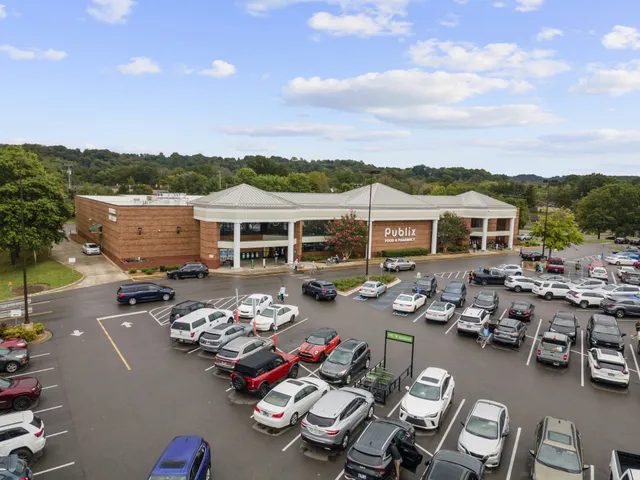 a picture of a patio with table and chairs barbeque potted plants and large tree