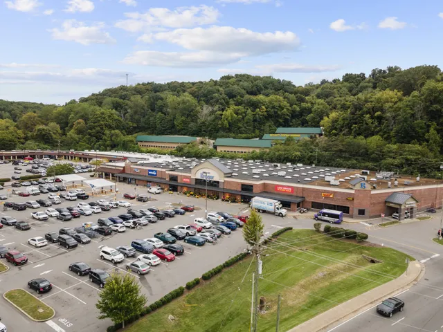 an aerial view of a pool a yard and mountain view in back