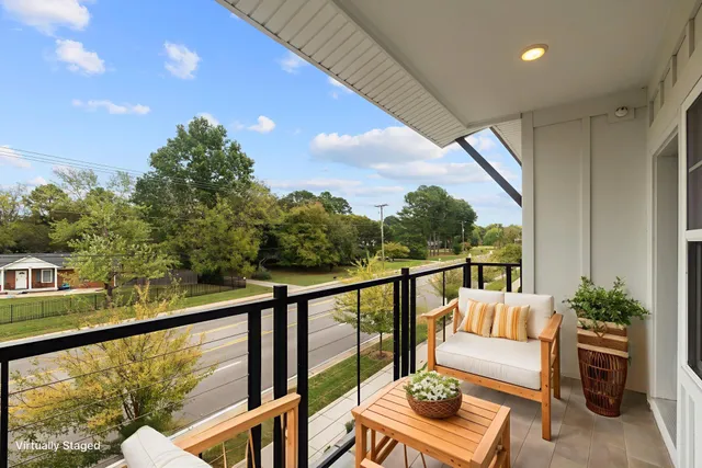 a balcony with furniture and wooden floor