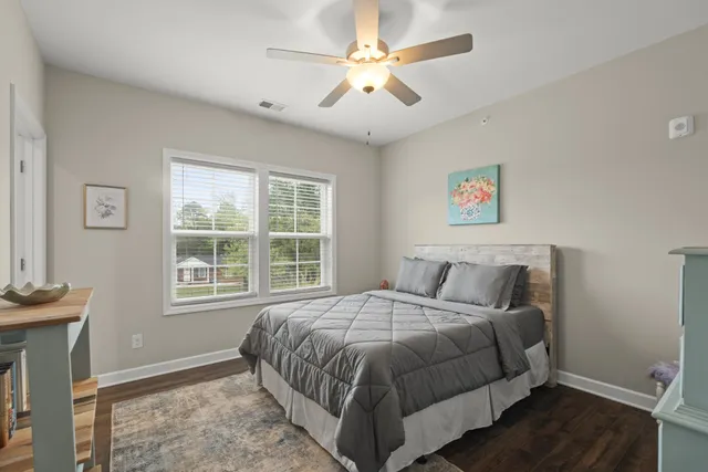 a bedroom with a large bed and a window
