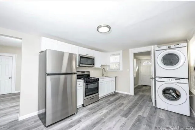 a utility room with sink washer and dryer