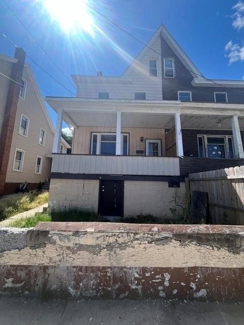 A classic facade with a covered front porch awaits a personalized touch.