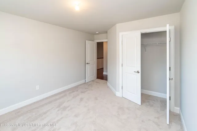 a view of an empty room and closet