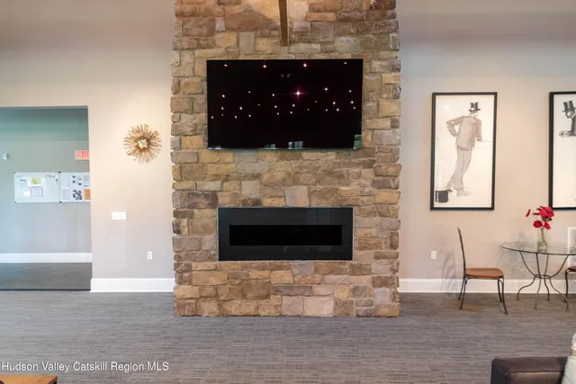 a dining room with furniture a large window and wooden floor