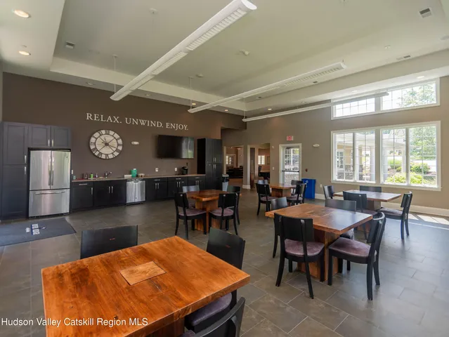 a room with pool table and windows