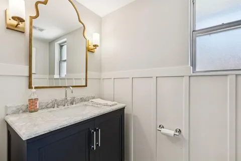 a bathroom with a sink vanity and a mirror