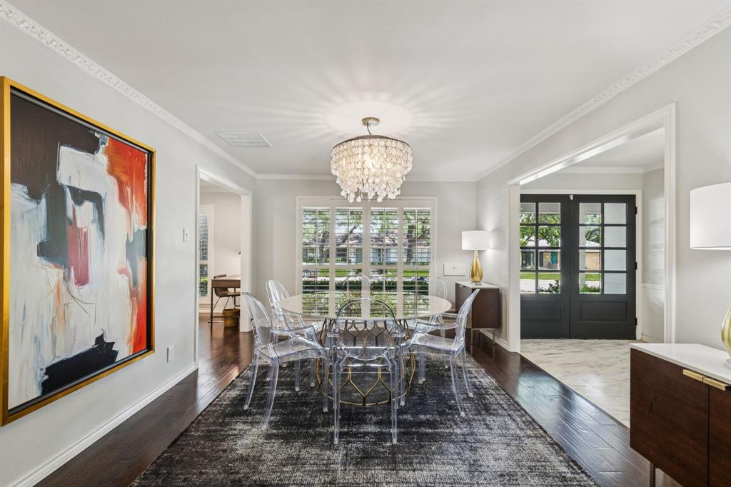 6222 East University Boulevard Dallas, TX 75214 - Photo 3 of 25 a dining room with wooden floor a chandelier a wooden table and chairs
