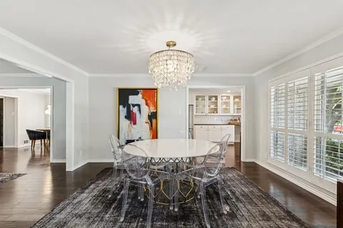 a view of a dining room with furniture wooden floor and chandelier