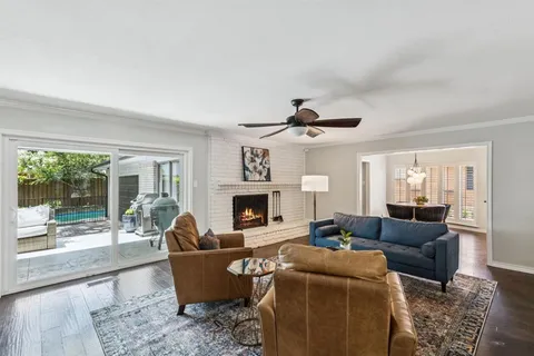 a living room with furniture a fireplace and a large window