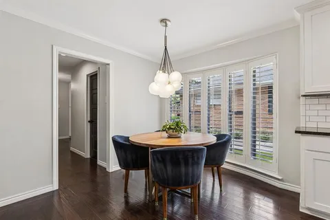 a dining room with furniture window and wooden floor