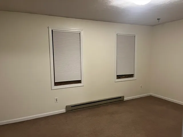 an empty room with a empty space and windows
