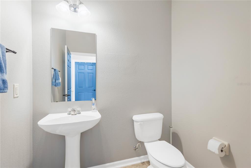 18345 Fish Loop Land O Lakes, FL 34638 - Photo 13 of 36 a bathroom with a toilet sink and mirror