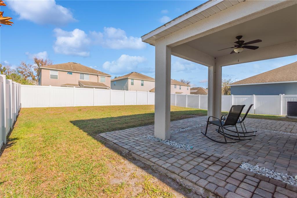 18345 Fish Loop Land O Lakes, FL 34638 - Photo 33 of 36 a view of a swimming pool with a chair and potted plants