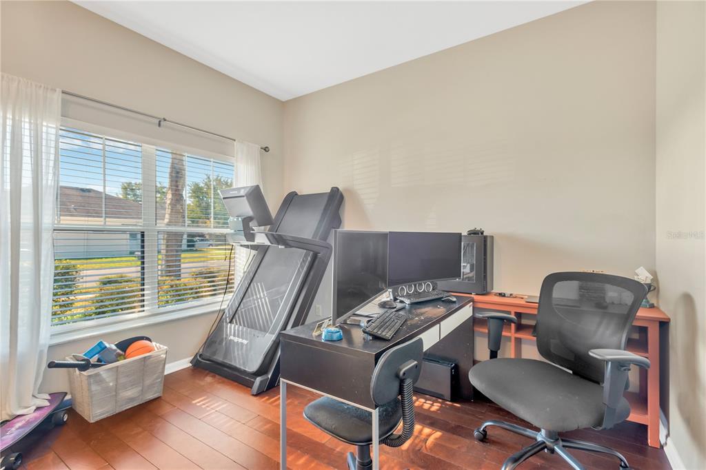 18345 Fish Loop Land O Lakes, FL 34638 - Photo 8 of 36 a view of workspace with wooden floor windows