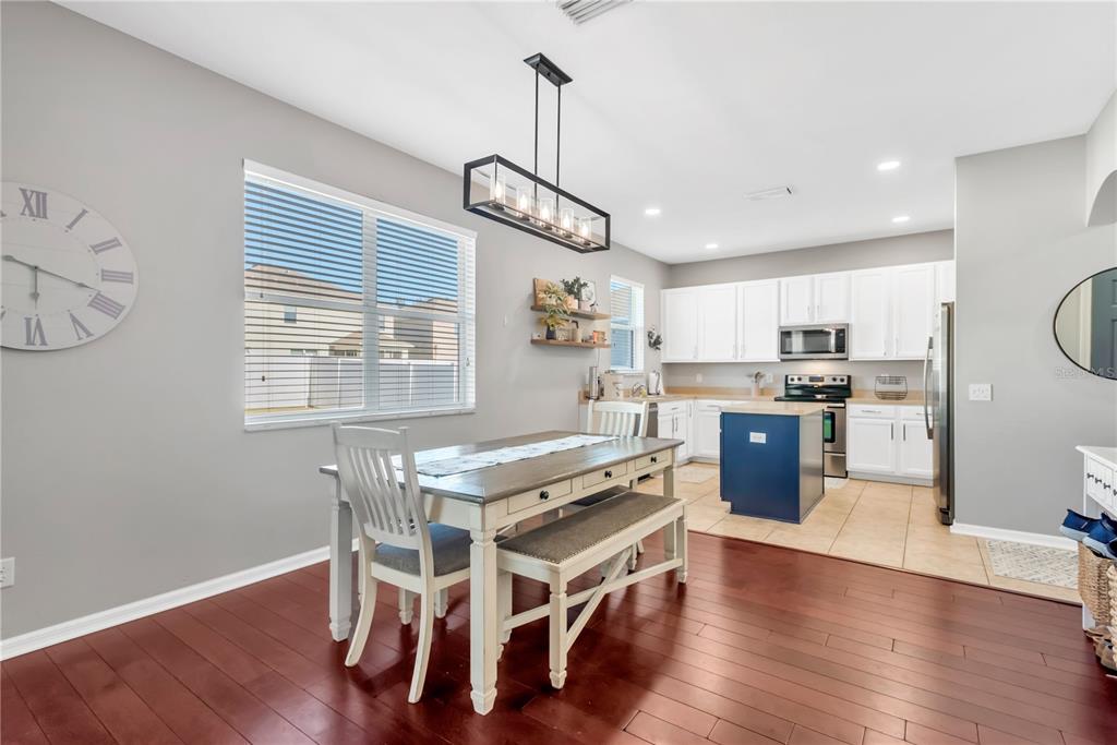 18345 Fish Loop Land O Lakes, FL 34638 - Photo 10 of 36 a view of a dining room with furniture wooden floor and chandelier