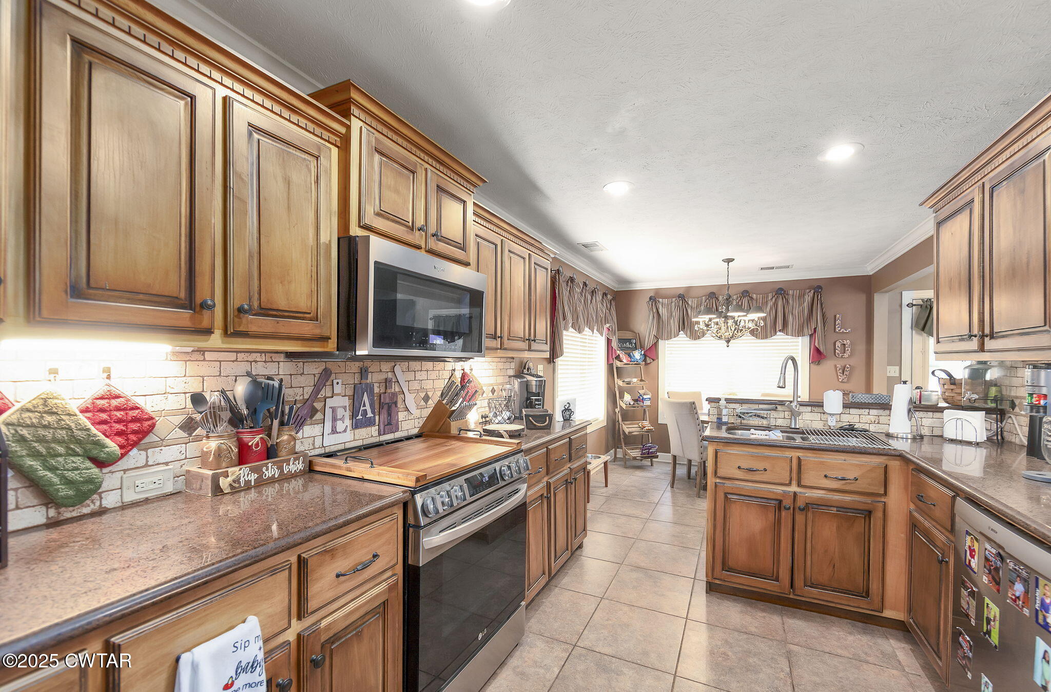 226 Fawn Ridge Lane Medina, TN 38355 - Photo 4 of 22 a kitchen with stainless steel appliances granite countertop a sink stove and cabinets