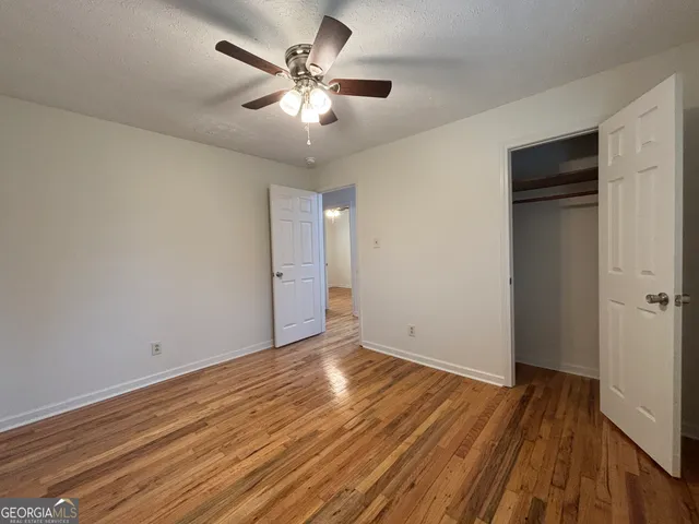 a room with a sink wooden floor and a window
