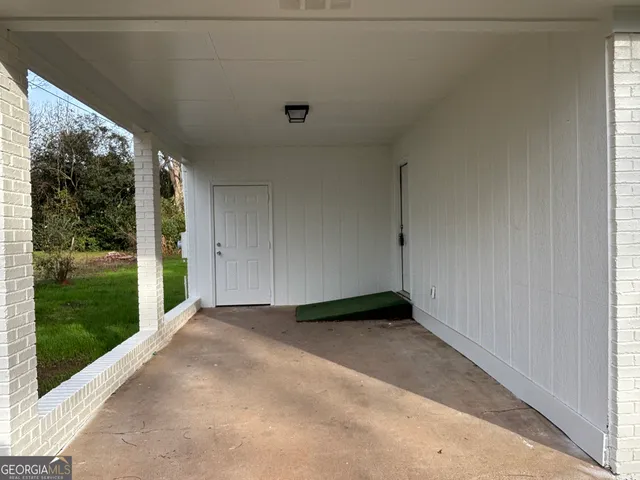 a view of a big room with yard and mountain view in back