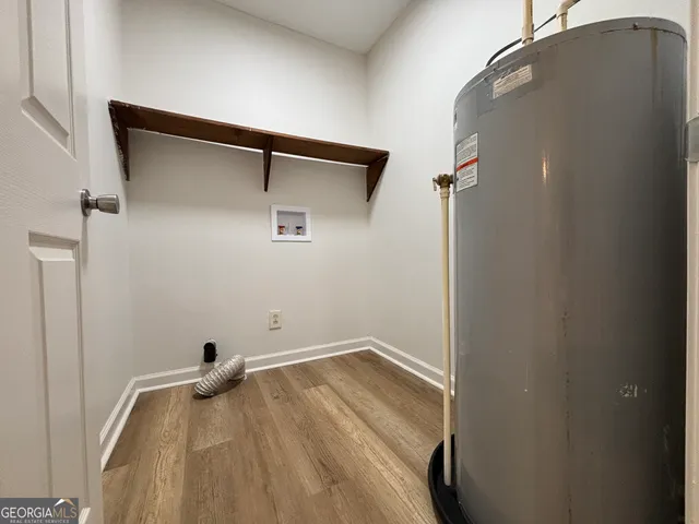 a view of a kitchen with a stove cabinets and wooden floor