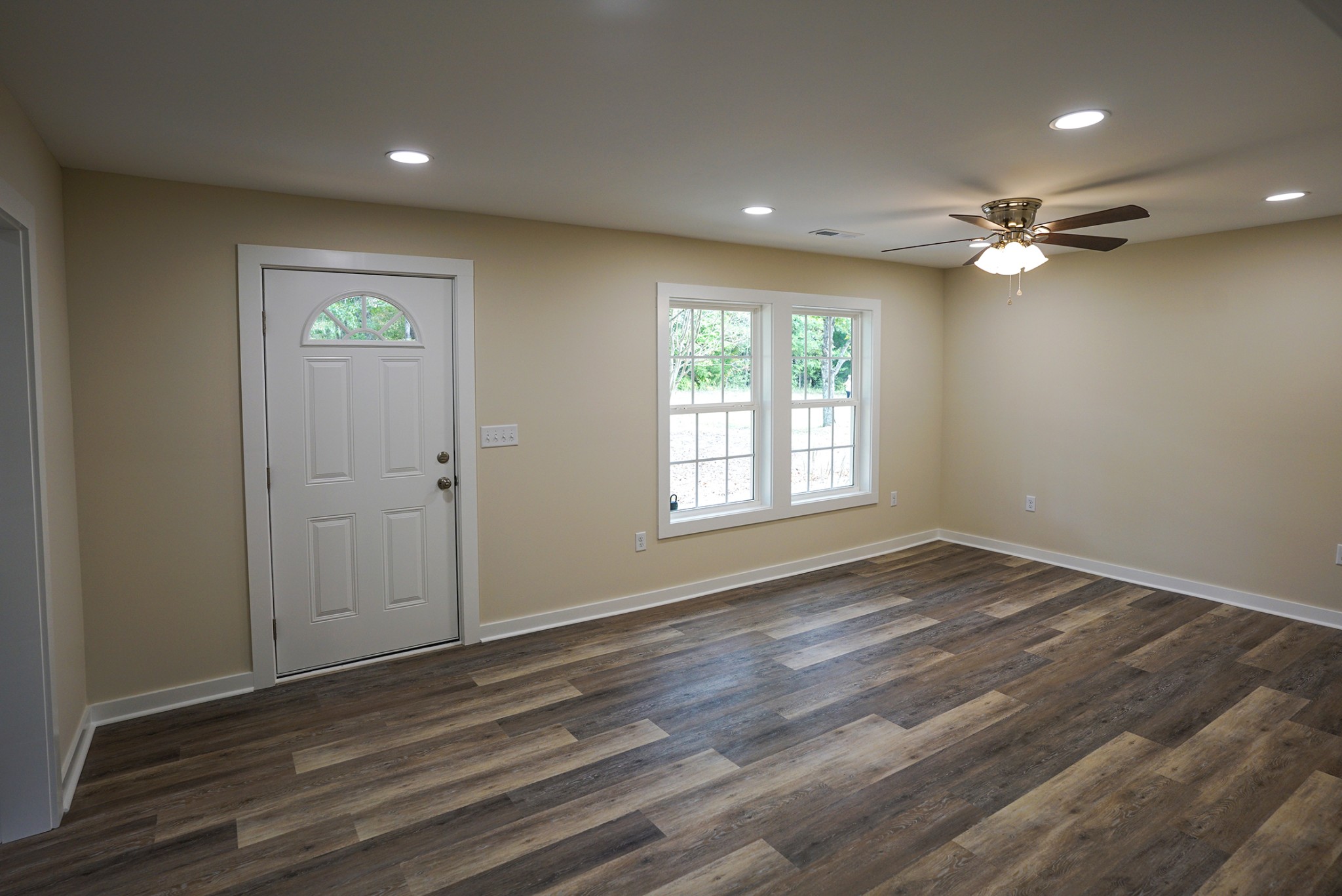 1080 Manley Loop Dickson, TN 37055 - Photo 36 of 42 an empty room with wooden floor chandelier fan and windows