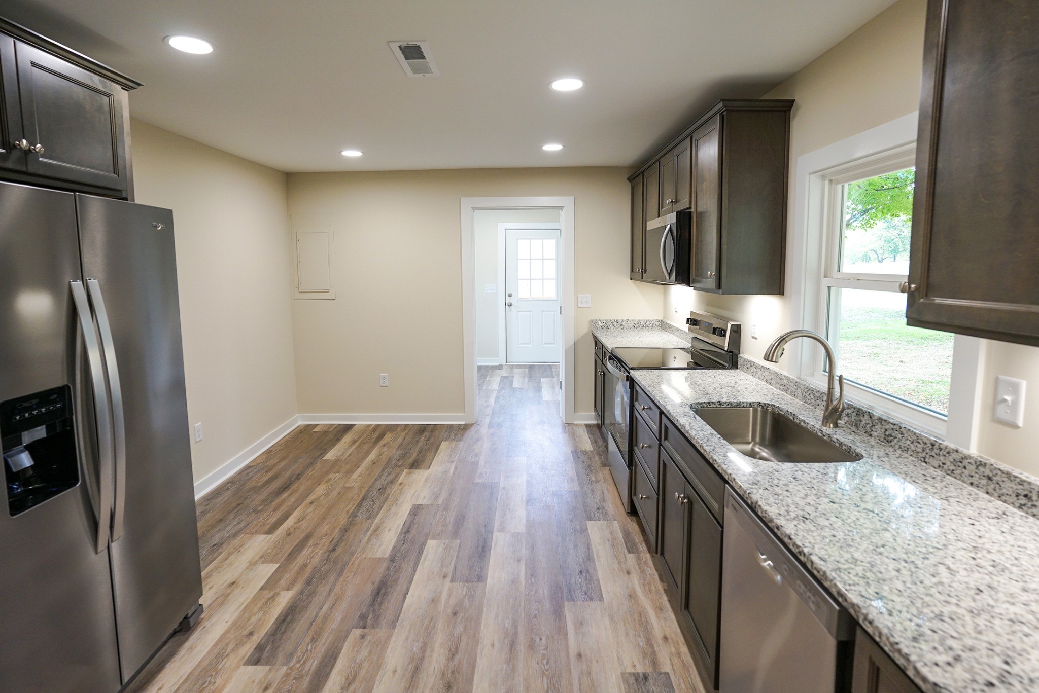 1080 Manley Loop Dickson, TN 37055 - Photo 38 of 42 a kitchen with granite countertop a sink stove and refrigerator