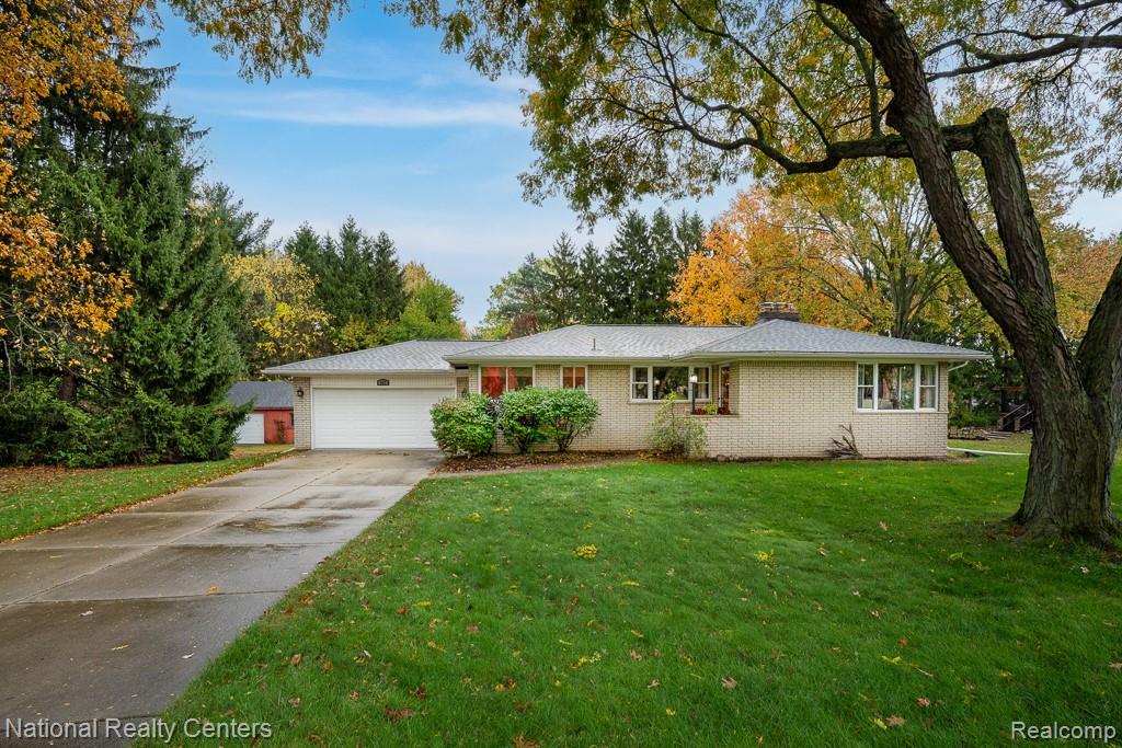 837 Dakota Court Rochester, MI 48307 - Photo 2 of 34 Single story home with brick siding, driveway, a front lawn, a chimney, and an attached garage