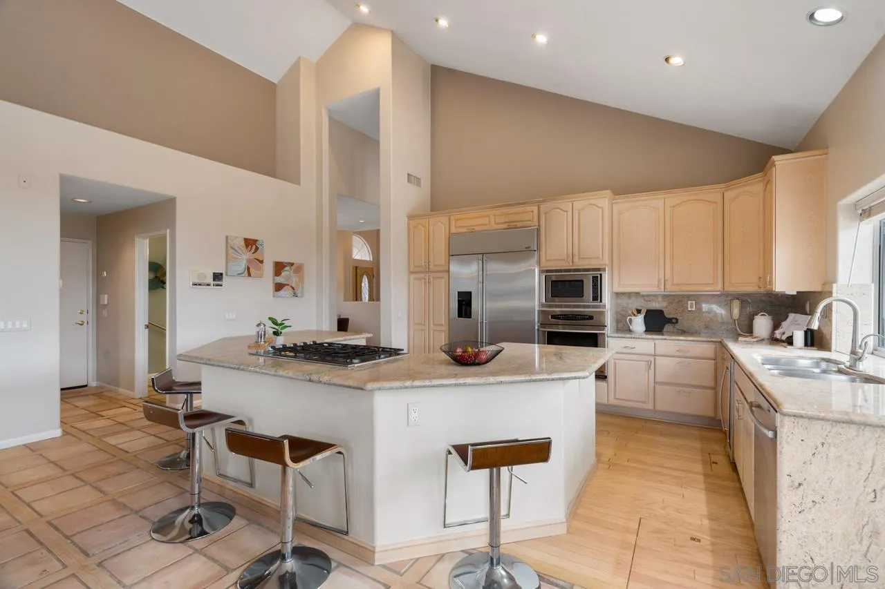 12245 Malabar Drive Poway, CA 92064 - Photo 17 of 43 a kitchen with stainless steel appliances kitchen island granite countertop a sink and cabinets