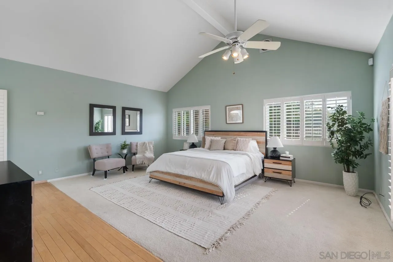 12245 Malabar Drive Poway, CA 92064 - Photo 25 of 43 a bedroom with a large bed and a chandelier