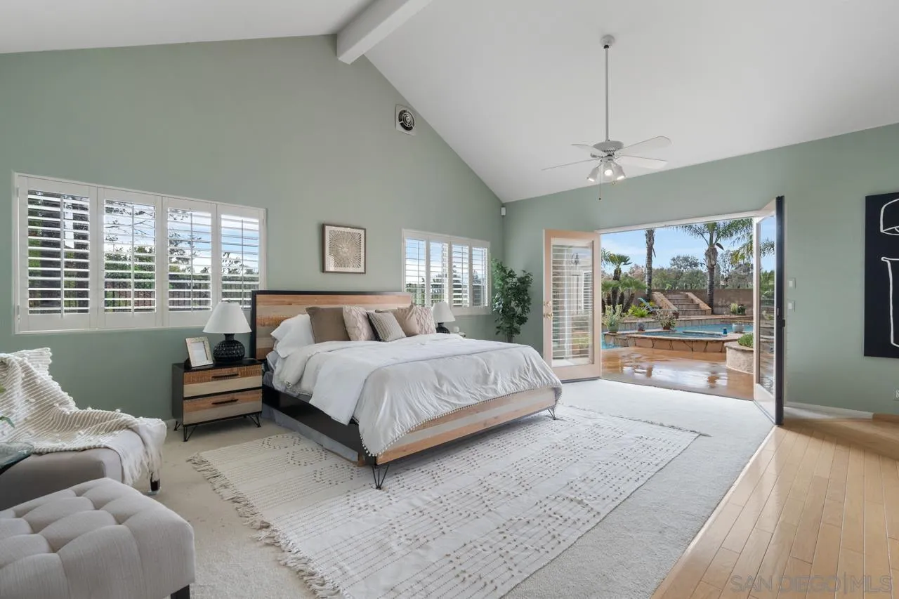12245 Malabar Drive Poway, CA 92064 - Photo 27 of 43 a spacious bedroom with a bed and a large window