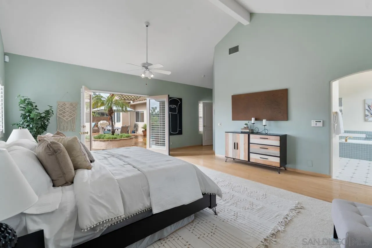 12245 Malabar Drive Poway, CA 92064 - Photo 28 of 43 a spacious bedroom with a bed a dresser and flat screen tv
