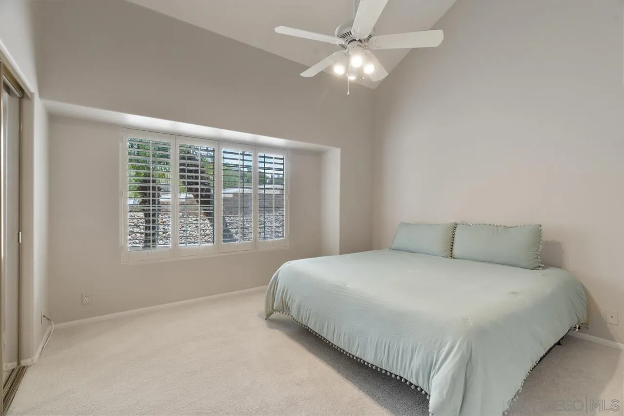 12245 Malabar Drive Poway, CA 92064 - Photo 31 of 43 a bedroom with a large bed and a chandelier