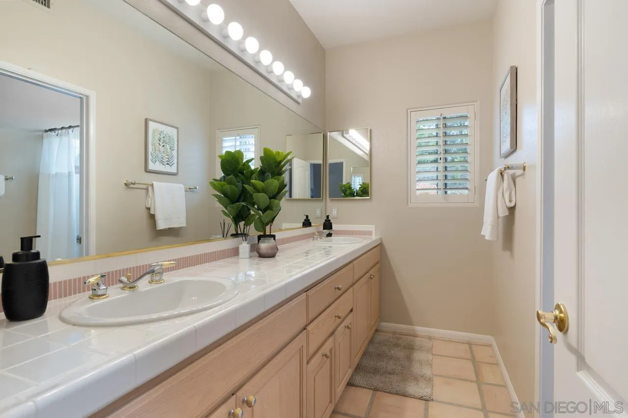 12245 Malabar Drive Poway, CA 92064 - Photo 32 of 43 a bathroom with a sink and a mirror