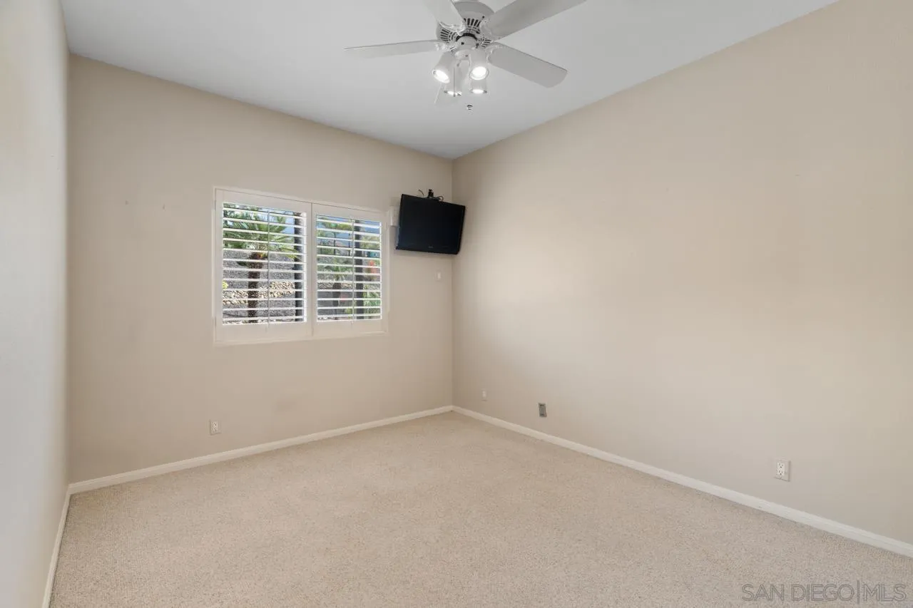 12245 Malabar Drive Poway, CA 92064 - Photo 33 of 43 an empty room with a ceiling fan and a window