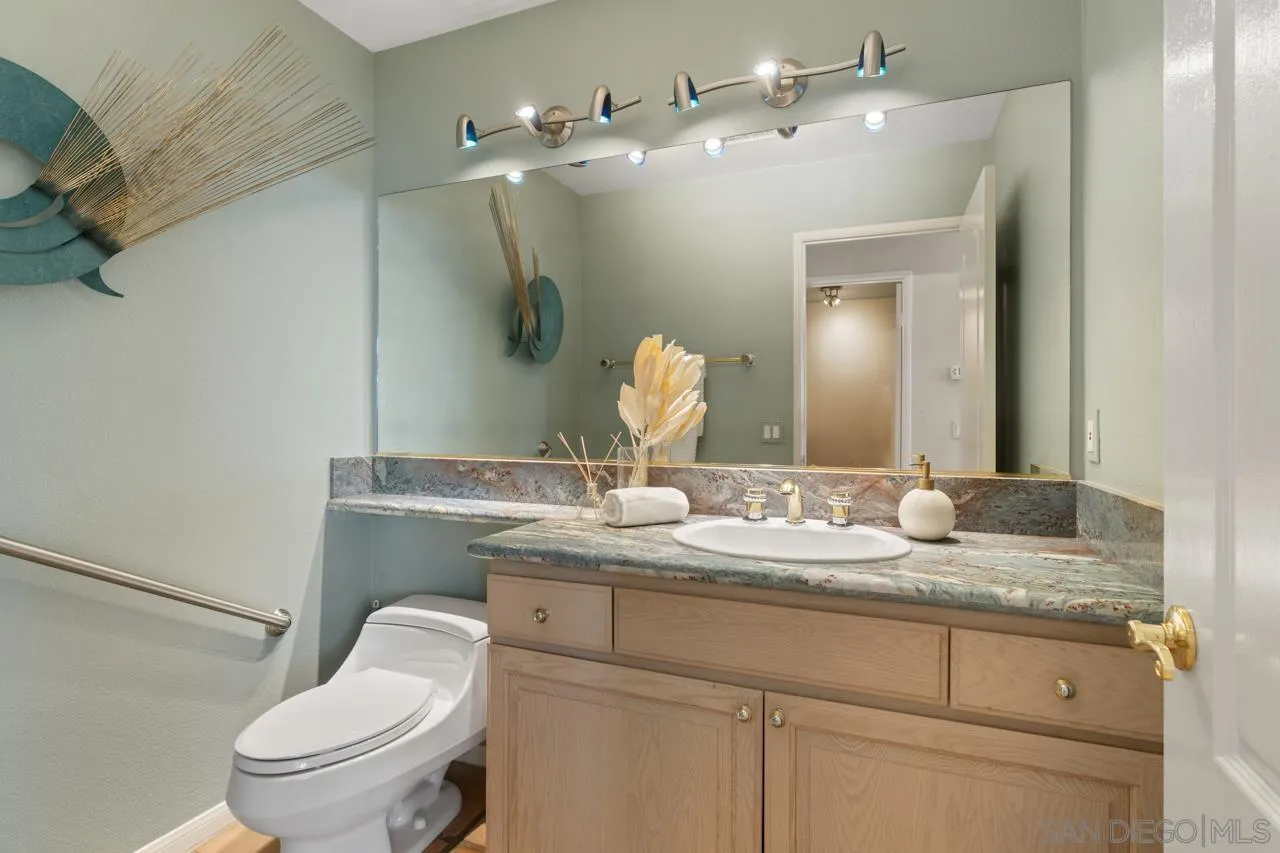 12245 Malabar Drive Poway, CA 92064 - Photo 34 of 43 a bathroom with a granite countertop toilet sink and mirror