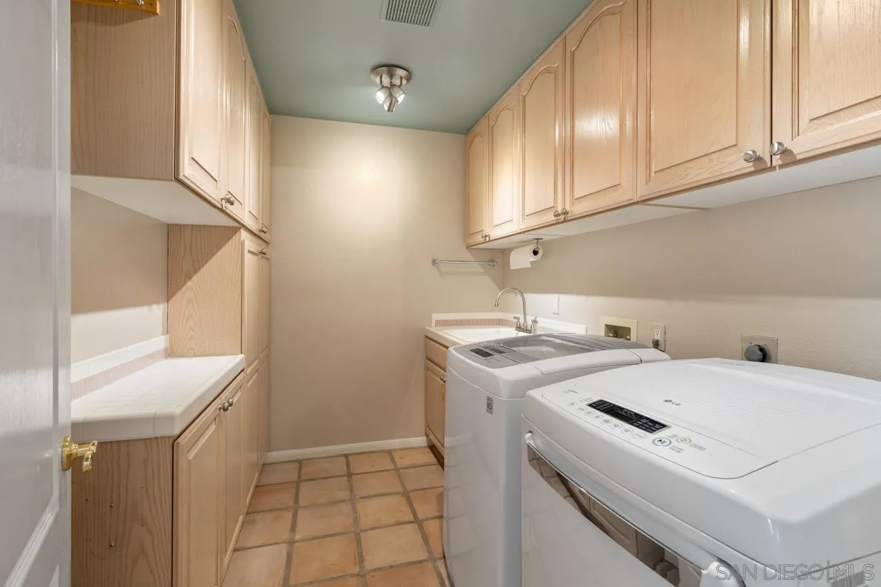 12245 Malabar Drive Poway, CA 92064 - Photo 35 of 43 a utility room with dryer and washer