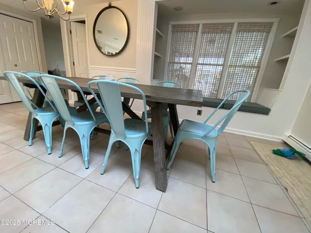 a view of a dining room with furniture and a chandelier