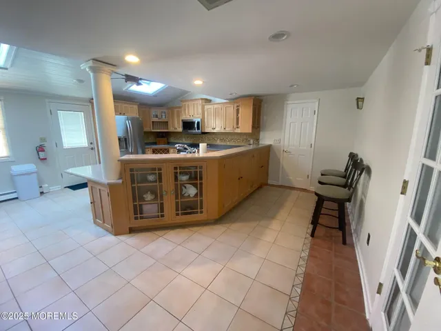 a large kitchen with stainless steel appliances granite countertop a stove a sink dishwasher and a refrigerator