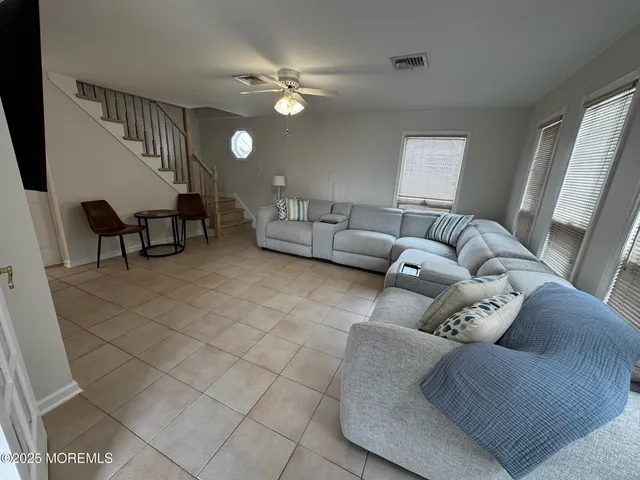 a living room with furniture and a lamp