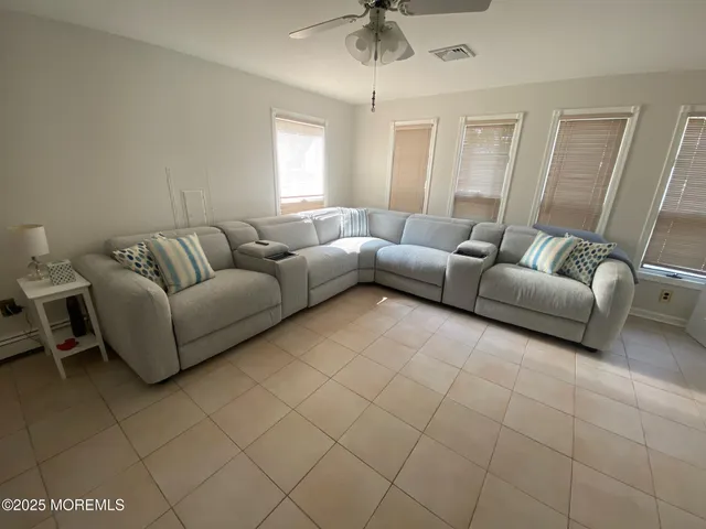 a living room with furniture and a chandelier