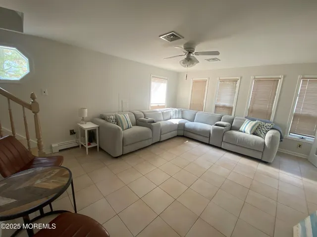 a living room with furniture and a chandelier