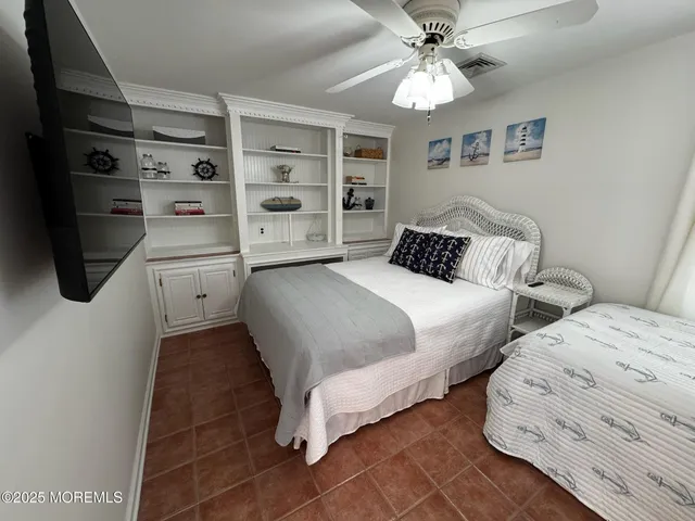 a bedroom with a bed a walk in closet and a window