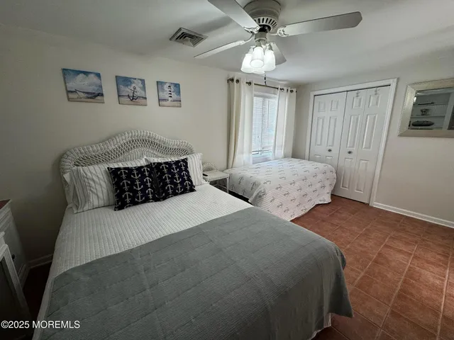 a bedroom with two beds and painting on the wall