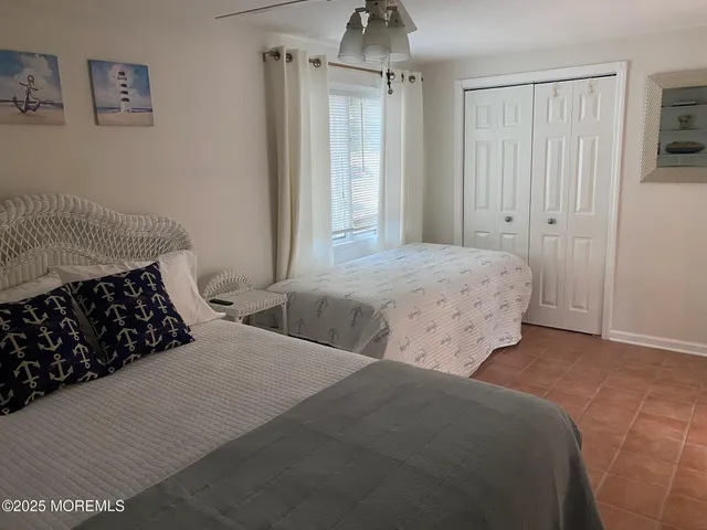 a bedroom with two beds and a window