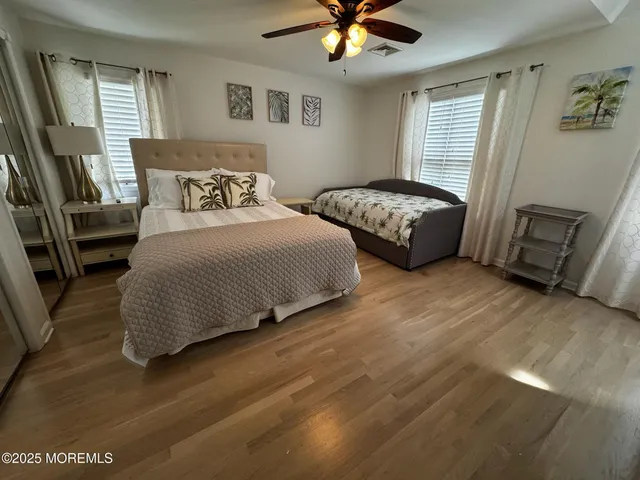 a bedroom with two beds and a chandelier