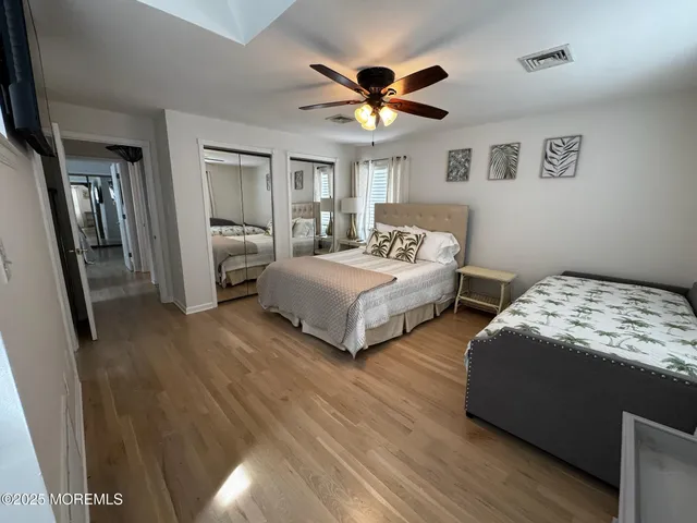 a bedroom with two beds and a chandelier