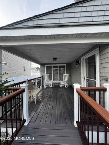a view of living room and hall with wooden floor