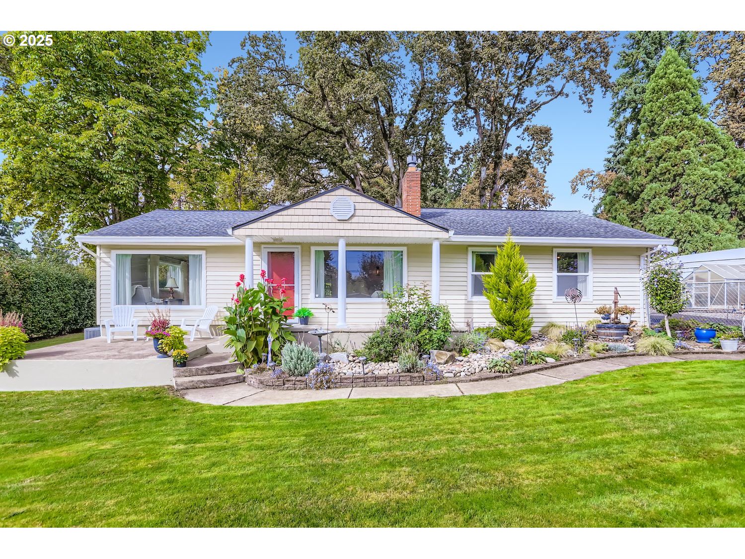 4711 Southeast Roethe Road Milwaukie, OR 97267 - Photo 1 of 30 a front view of a house with a yard table and chairs