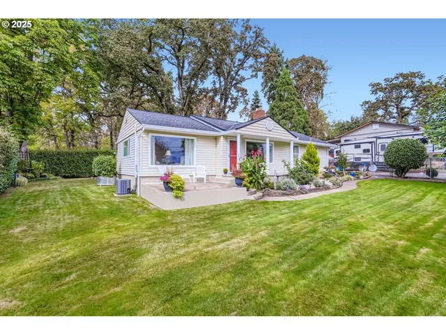 a front view of a house with a yard and potted plants