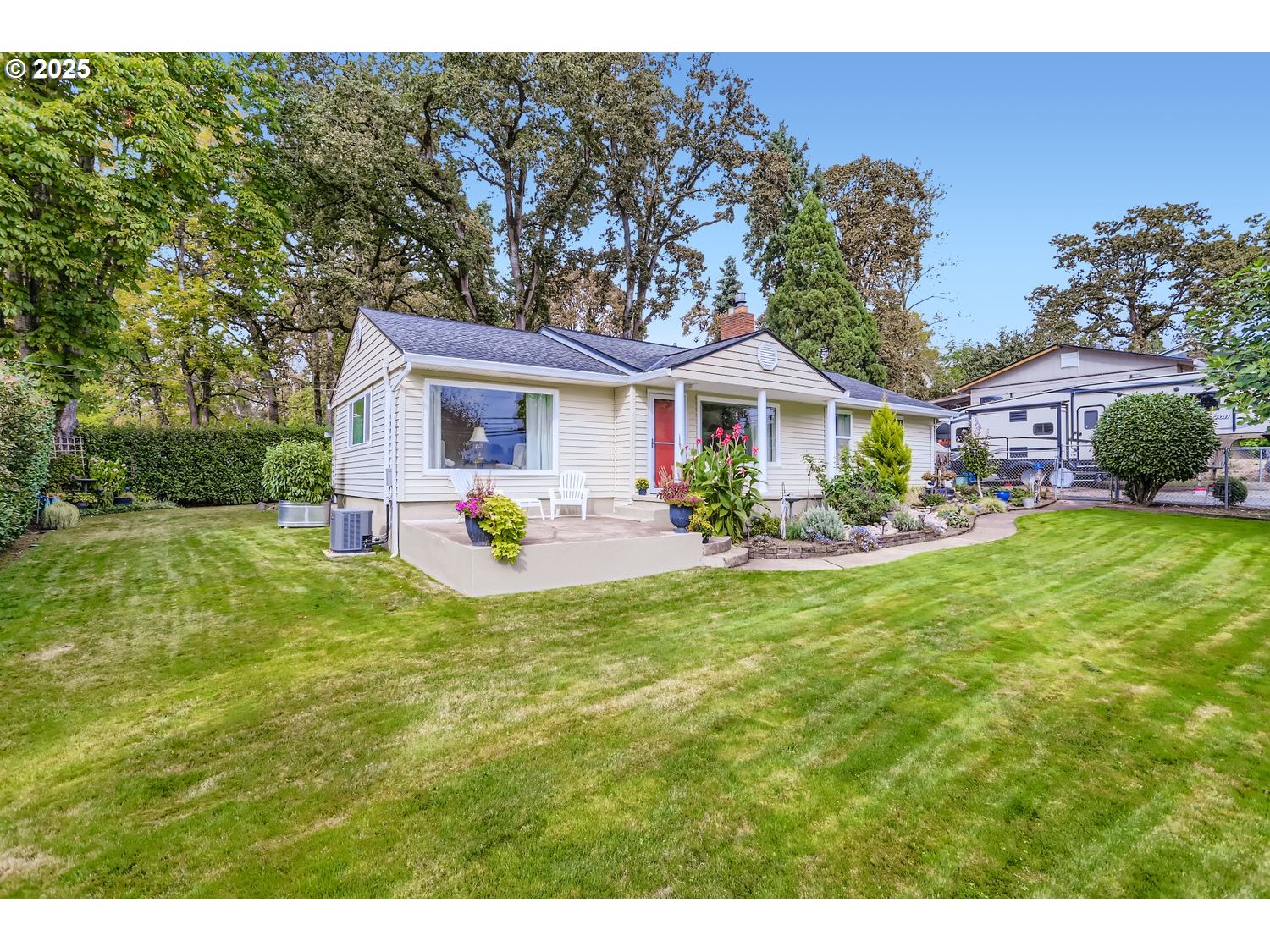 4711 Southeast Roethe Road Milwaukie, OR 97267 - Photo 2 of 30 a front view of a house with a yard and potted plants